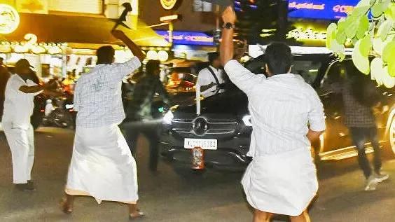 SFI students show black flags to Kerala Governor Arif Mohammed Khan as he was on his way to the airport, in Thiruvanathapuram