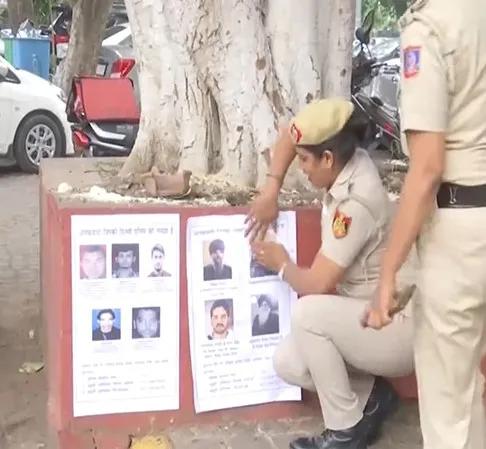 Delhi Police putting posters of Al-Qaeda terrorists