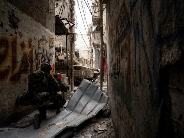 An Israeli soldier takes position during the ongoing ground operation by the Israeli army, in a location given as Gaza