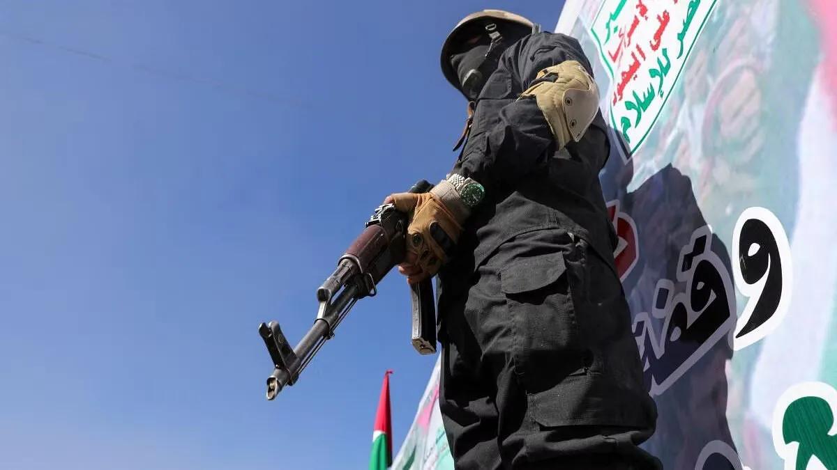 A Houthi fighter stands guard during a ceremony