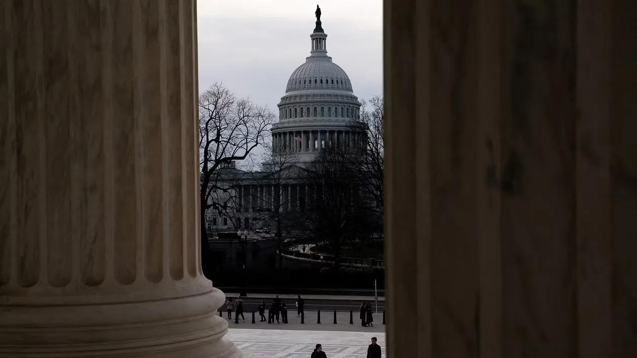 A file photo of tourists walk near the US Capitol