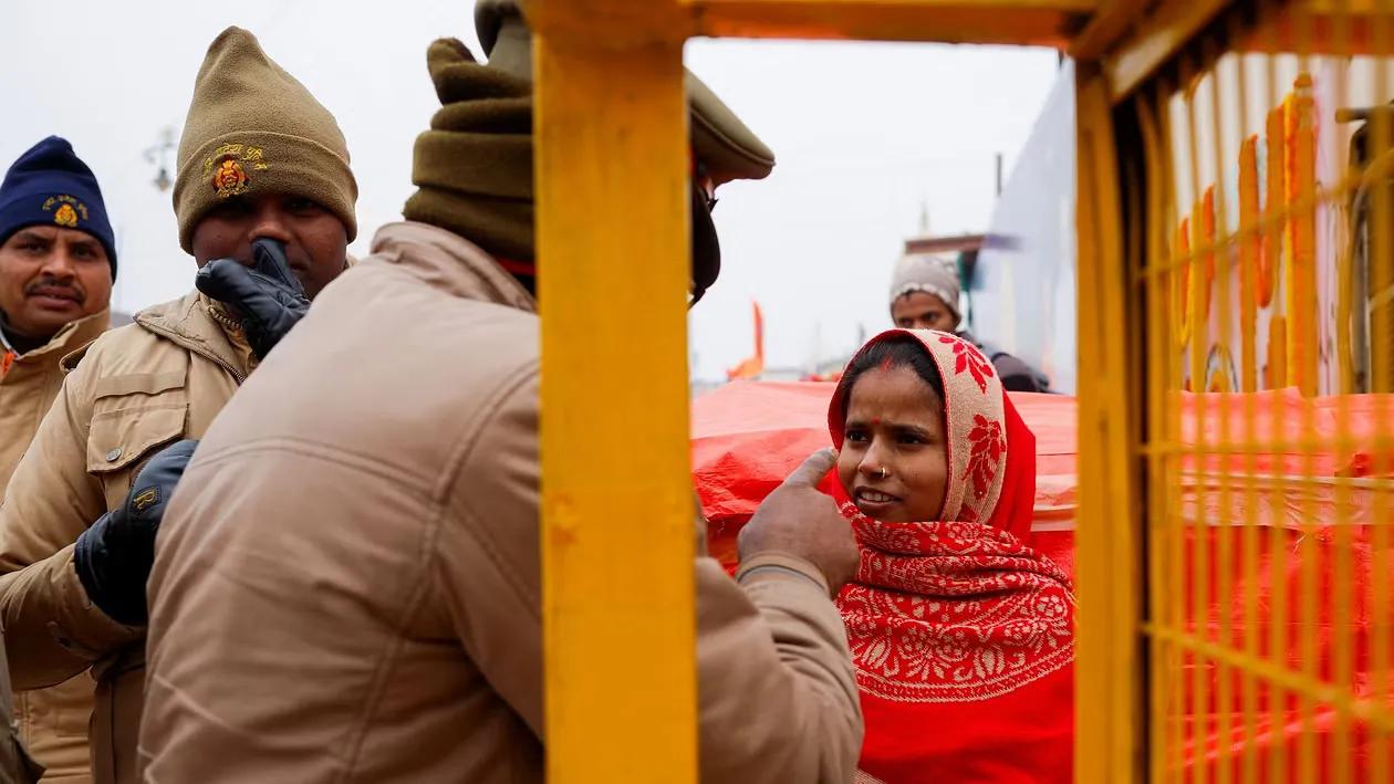 Police officers speak to Hindu devotee on the Ayodhya Ram temple premises