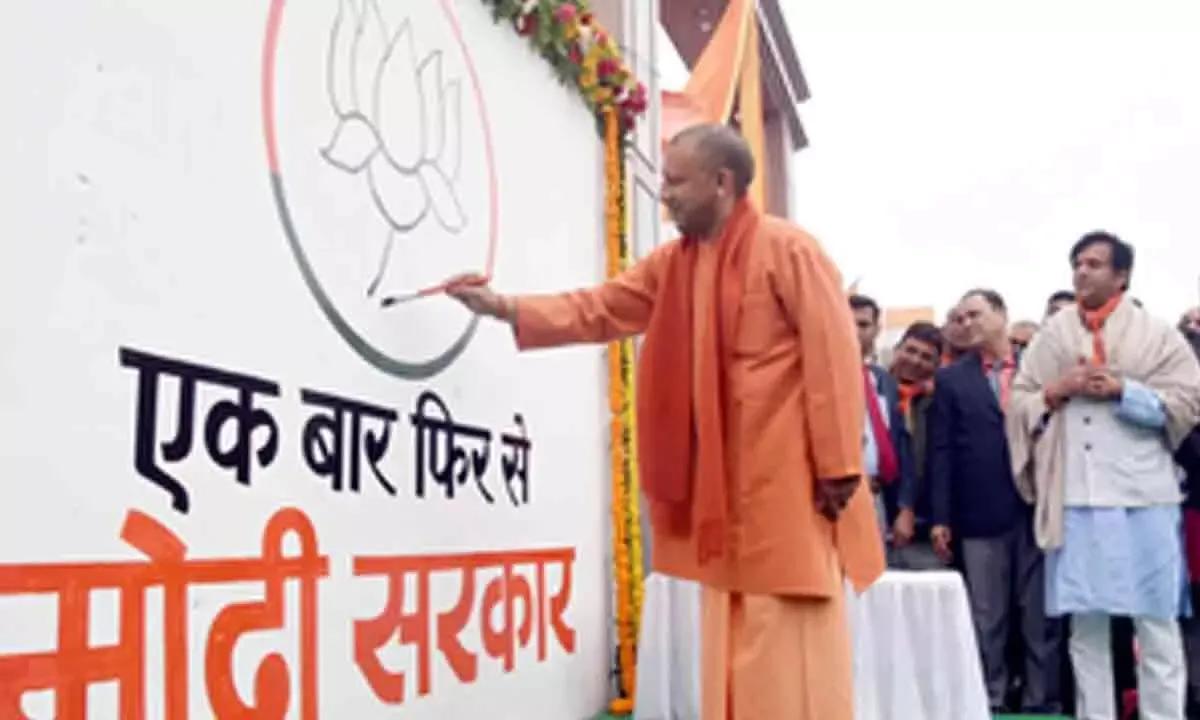 Yogi Adityanath participates in BJP's wall writing campaign